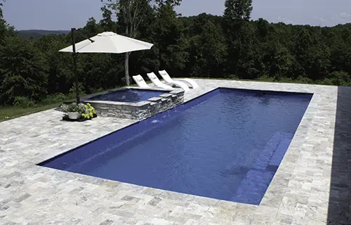 Leisure Pools The Grand rectangular fiberglass composite pool for lounging, installed by Leisure Pools Durham
